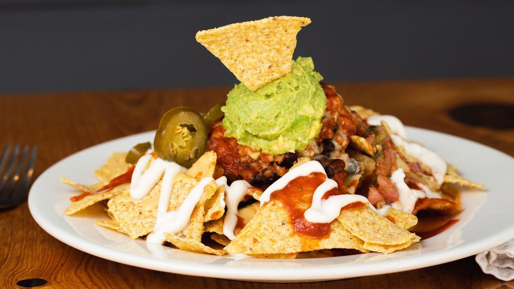 Nacho Mama · Gluten free. Mesquite jackfruit, black beans and rice, red sauce, cheese, sour cream, salsa fresca, black olives and guacamole.
