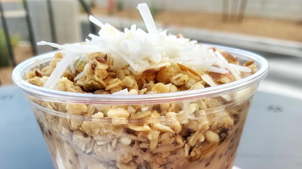 Vegan Overknight Oats · Rolled oats, soy milk, peanut butter, chia seeds, vanilla, banana, shaved coconut, pumpkin flax granola, almonds, agave, chilled.