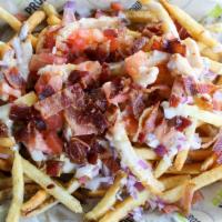 Rarebit Fries · Large fries, house beer-cheese rarebit sauce, bacon, red onion, tomato.