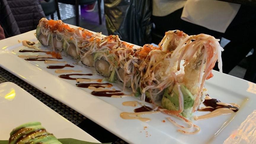 Summer Roll · Tempura shrimp, yellowtail inside, avocado, kani and tobiko on top with special sauce.
