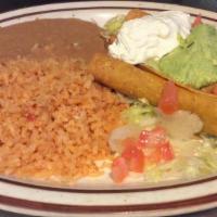 Beef Flautas · 4 Fried corn tortilla taquitos topped with Mexican style cream and guacamole. served with le...