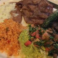 Carne Asada · Tender steak grilled to perfection served with guacamole, pico de gallo, chile asado, beans ...