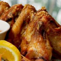 Crispy Garlic Wings · Four jumbo sized chicken wings marinated with fresh garlic and spices. Deep fried and served...