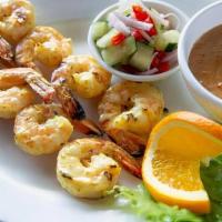 Satay Prawns. · Barbecued Prawns marinated in coconut milk and a mixture of Thai spices. Served with our fam...