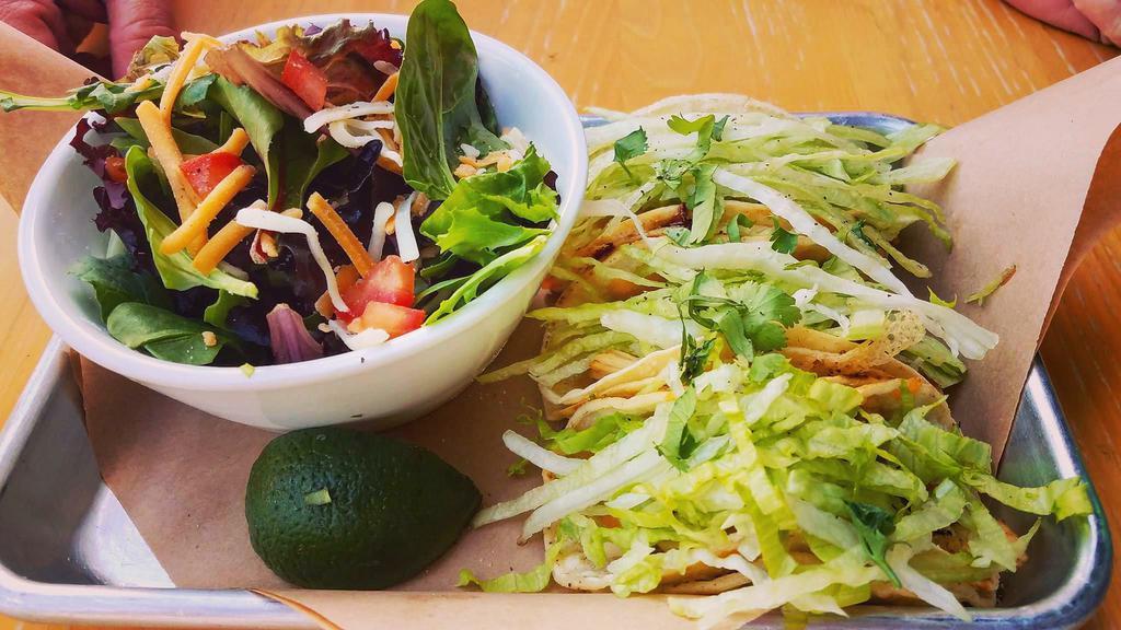Taqueso Platter · 3 chicken street tacos in a corn tortilla quesadilla taco shell. Topped with shredded lettuce, fiesta blend cheese, salsa verde and cilantro and a lime wedge. Served with hand cut fries or fruit and a dipping sauce.