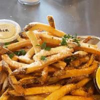 Truffle Fries · Hand cut fries, tossed in salt and pepper, truffle oil and Parmesan cheese, garnished with p...