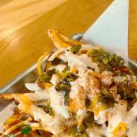Gringo Fries · Hand cut, Cajun seasoned fries and topped fiesta blend cheese, queso blanco and salsa verde.