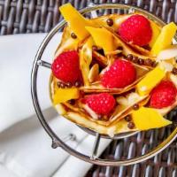 Mango Raspberries Crepe · Fresh mango, raspberries, custard cream, whipped yogurt, chocolate pearls, chocolate sauce, ...