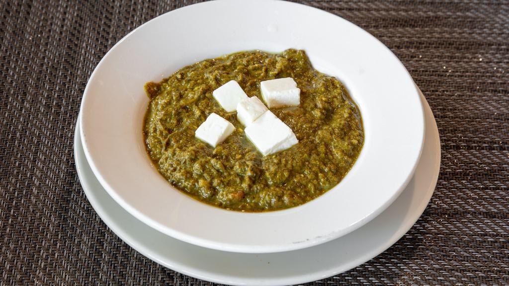 Palak Paneer · Tender chunks of Indian cottage cheese cooked in a creamy spinach sauce