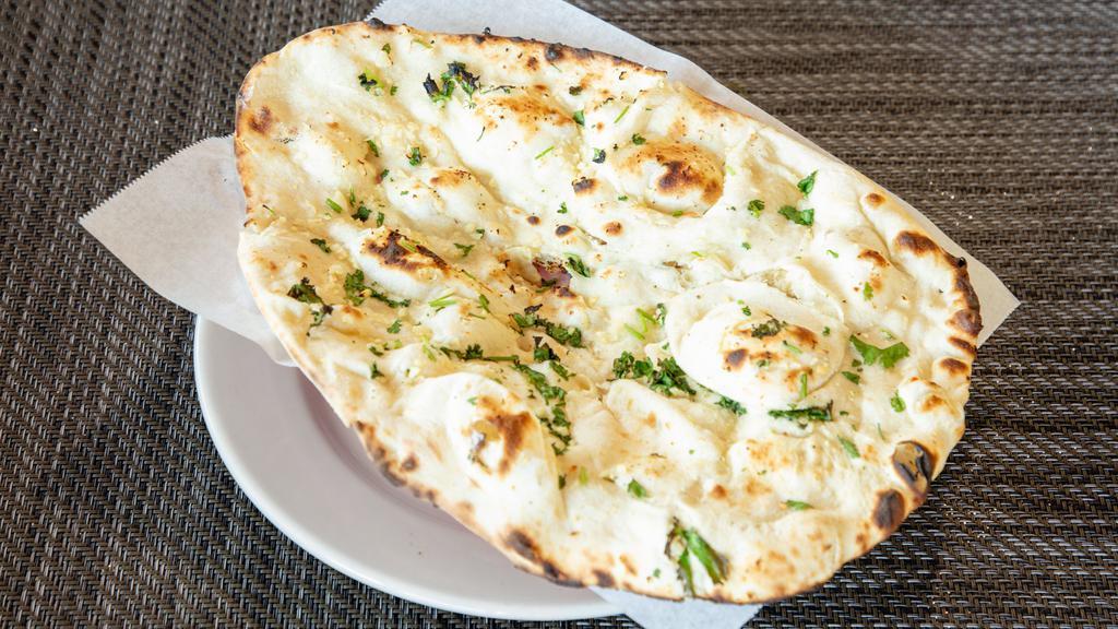 Garlic Naan · White leavened garlic sprinkled bread baked in clay oven