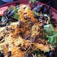 Taco Salad · Organic harvest blend greens with taco meat, avocado, black olives, tomato, onion, and a sid...