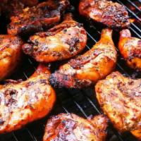 Large Drum Pan Jerk Chicken · The poultry is seasoned with a jerk sauce that combines all spices, fresh herbs and seasonin...