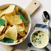 Queso Dip · Dip into a warm blend of selected cheeses, jalapeños, fire roasted peppers and onions, all b...