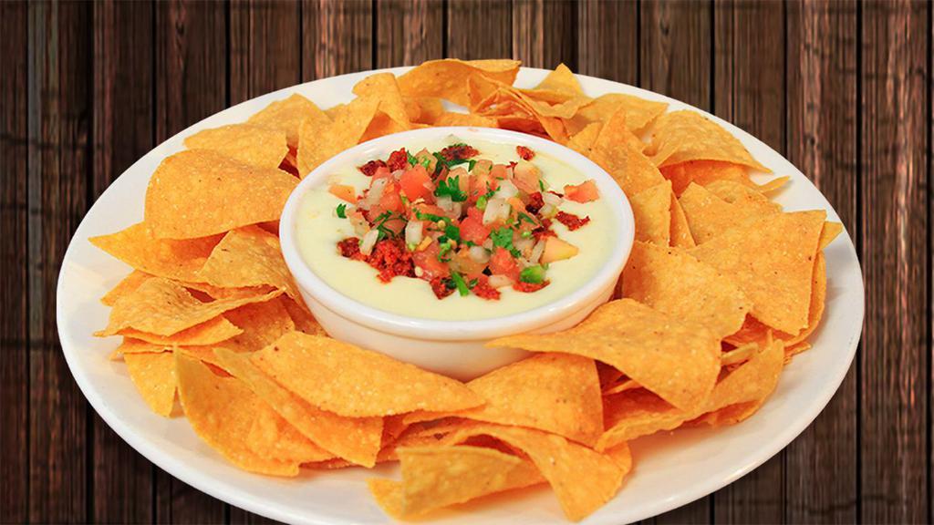 Queso Dip · A delicious salsa made of melted cheeses. Topped with pico de gallo. Served with tortilla chips.