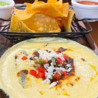 Queso Dip · A Dilicious salsa made of melted cheese. Topped with pico de gallo. Served with tortilla chips