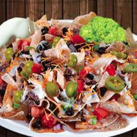 Antojo Nachos · Choice of meat - shredded beef, ground beef, chicken, steak and refried beans. Topped with b...