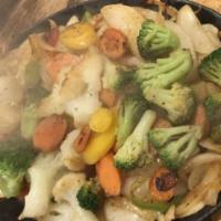 Veggie Fajitas · A sizzling hot bed of sautéed onions, red and green peppers, broccoli, cauliflower, zucchini...