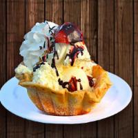 Taco Ice Cream · Three scoops of vanilla ice cream served on a fried taco shell. Served with whipped cream an...