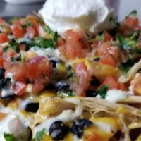 Nachos Grande · Homemade tortilla chips layered with mixed cheese, black beans. Then top it all off with pic...