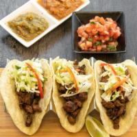 Carne Asada Tacos · Marinated flank steak, fire grilled and topped with Pico de Gallo and  lime infused Cabbage ...