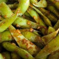 Sweet & Spicy Edamame · Wok seared edamame tossed with sauteed garlic and a sweet & spicy soy glaze, garnished with ...