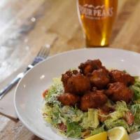 Buffalo Chicken Caesar · Crispy, beer-battered chicken in house buffalo sauce over romaine lettuce, Parmesan cheese, ...