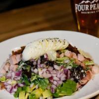 Four Peaks Cobb Salad · Mixed greens tossed in buttermilk ranch dressing and topped with smoked turkey, bacon, gorgo...