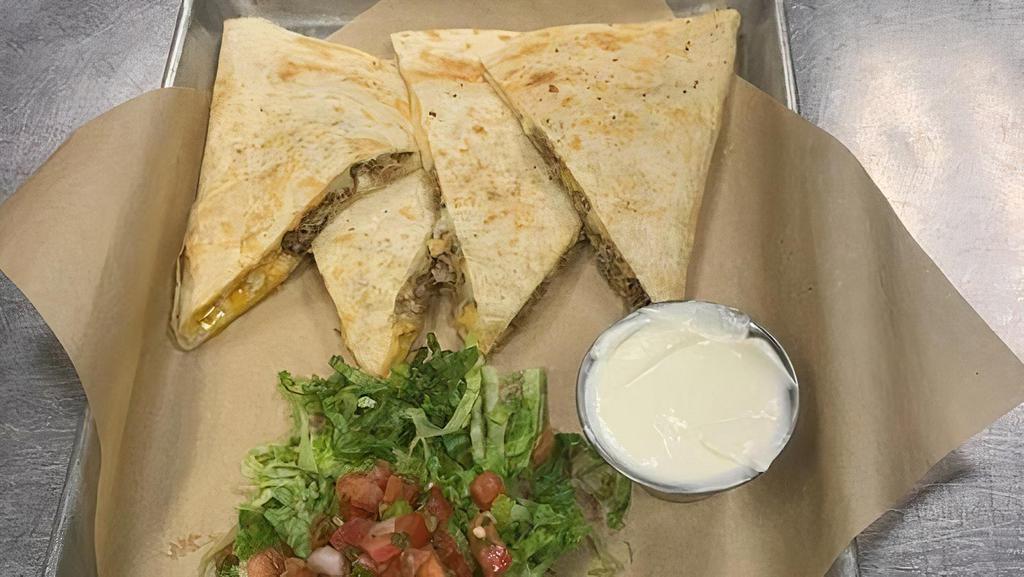 Green Chili Pork Quesadilla · Slow roasted, green chili pulled pork, cheddar and mozzarella cheese blend melted in a toasted flour tortilla. Served with a side of salsa and sour cream.