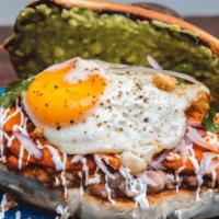 Chilaquil Torta · Macrina ciabatta bun, beans, eggs, chilaquiles with its toppings(sour cream, cotija cheese, ...