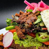 Mexican Toast · Slice of macrina white batard sourdough bread, hummus and guacamole, tomato layers, greens, ...