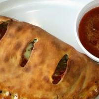 Calzone · Pizza dough folded and stuffed with mozzarella and ricotta cheese. Served with 1/2 pint of p...