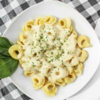 Family Cheese Tortellini Alfredo · Served with garlic bread and salad.