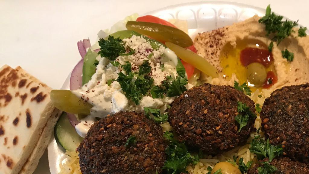 Falafel Plate · Five pieces falafel on top of basmati rice served with Greek salad, hummus, and one pita.