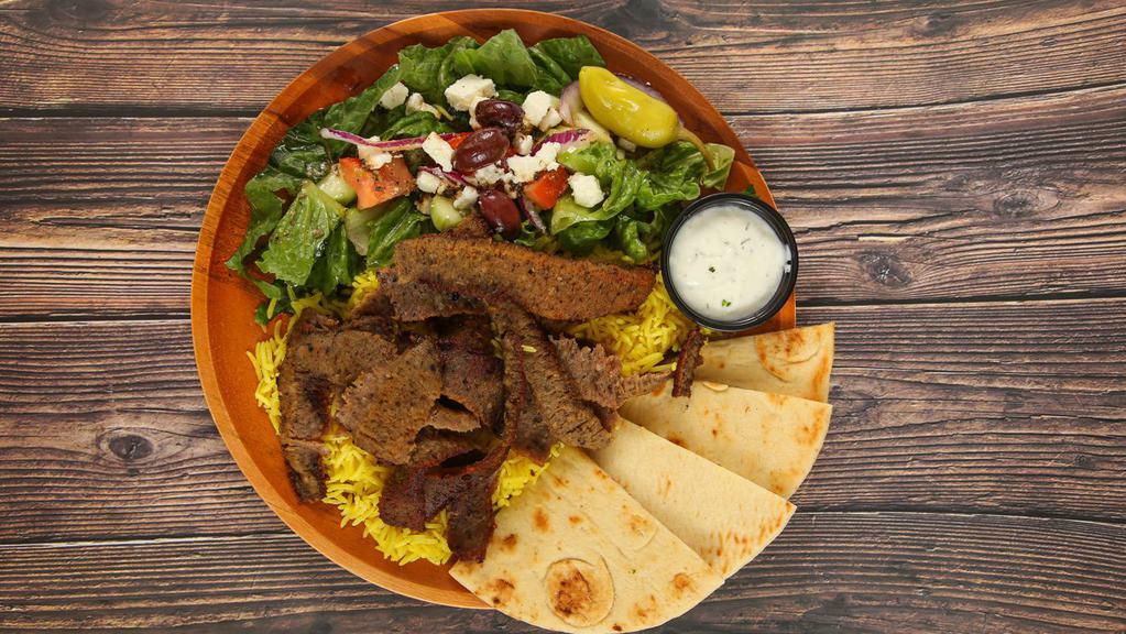 Gyros Entree · Layers of select beef and lamb, perfectly seasoned with zesty spices; broiled on a vertical skewer, with choice of 2 sides. Served with a sauce, and pita bread.