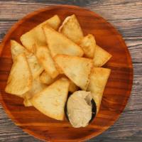 Pita Chips & Hummus · Signature fried pita chips served with your choice or original hummus or cilantro jalapeño.