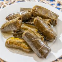 Dolmathes · Grape leaves stuffed with rice and herbs, served with side of tzaziki. 6 pieces