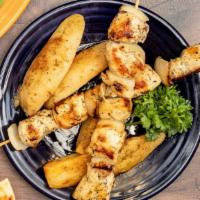 Chicken Souvlaki (Kabob) · Marinated chicken on a skewer with onions in between cooked perfectly ( 2 skewers), served w...