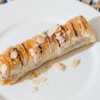 Chocolate Nut Roll · Crispy phyllo dough rolled with almonds, syrup and drizzled with chocolate