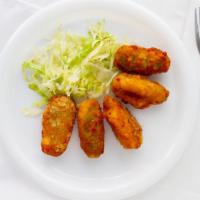 Chile Poppers · Cream cheese stuffed jalapeno peppers. dipped in spicy breading and fried until golden crisp.