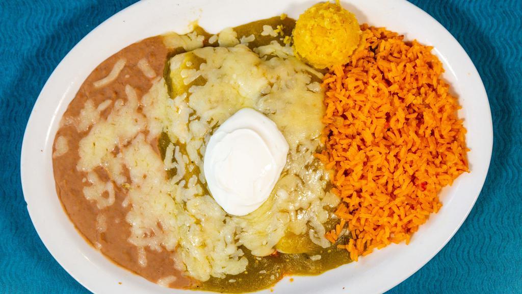 Enchilada Suiza · 2 corn tortillas stuffed with your choice of filling. topped with a delicious green tomatillo sauce and melted cheese garnished with sour cream.
