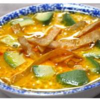 Tortilla Soup · A chicken broth and tomato base soup topped with avocado, crispy tortillas, cheese and a dol...