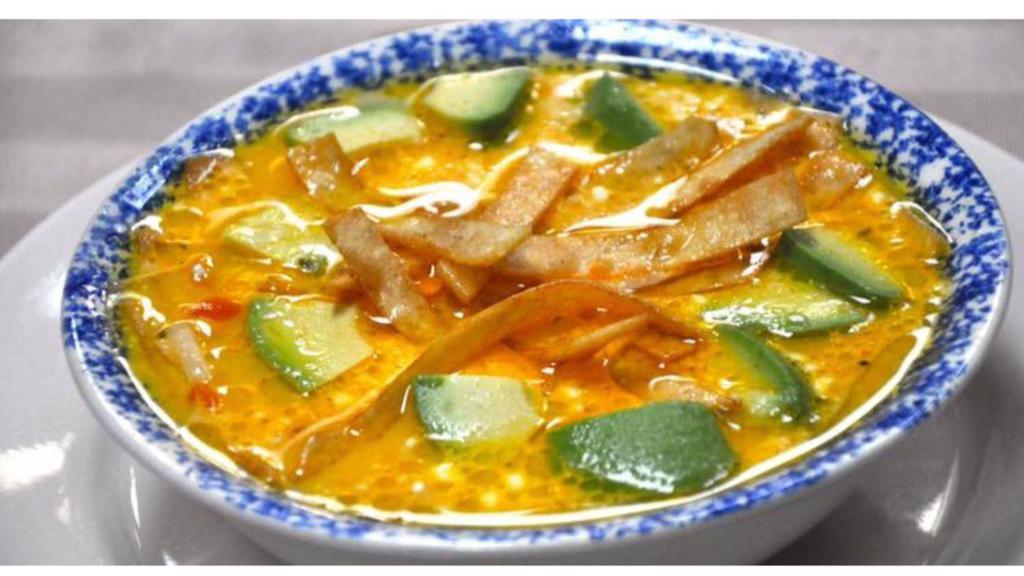 Tortilla Soup · A chicken broth and tomato base soup topped with avocado, crispy tortillas, cheese and a dollop of sour cream
