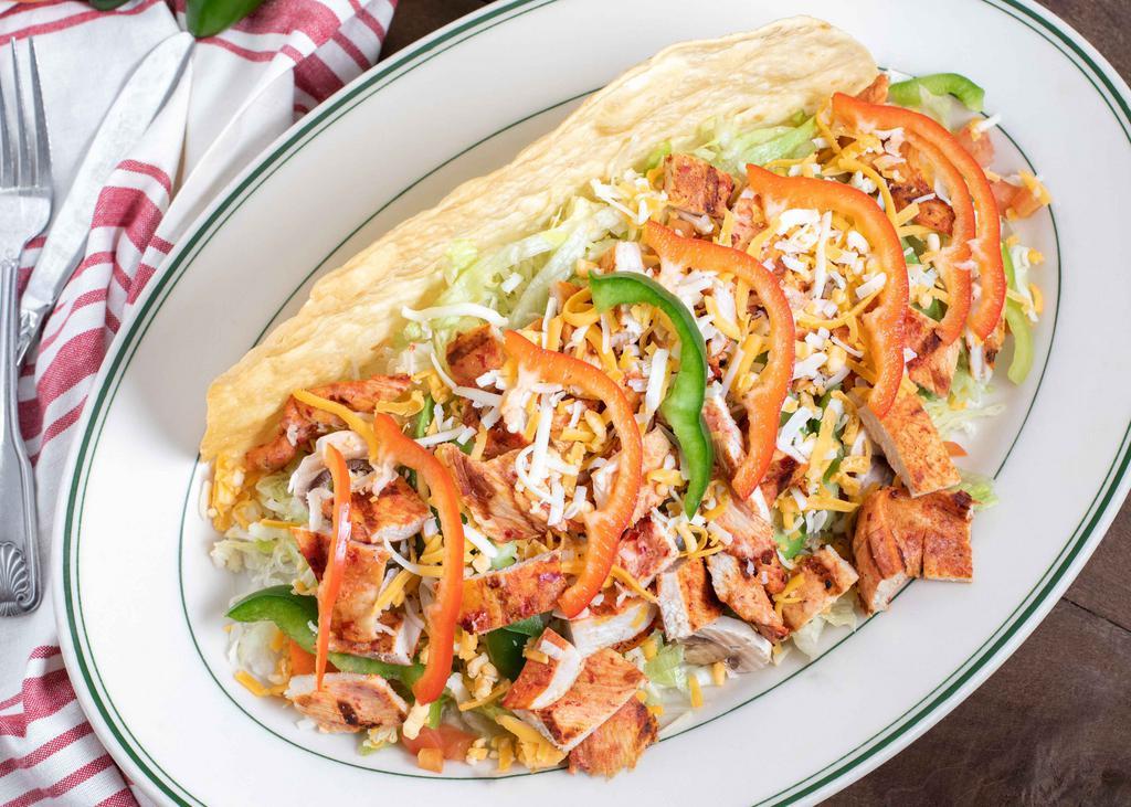 Grilled Chicken Salad · Tender pieces of charbroiled chicken. served in a fried flour tortilla with lettuce tomatoes avocado and sour cream.