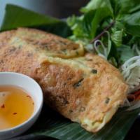 Vietnamese Crepe (Bánh Xèo) · Filled with BBQ pork, shrimp, bean sprouts, and scallions served with green leaf, mango slic...