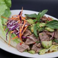 Beef Salad / Yum Neu · Cooked sliced steak, cilantro, green onions, red onions, cucumber, tomatoes, and fresh lettu...