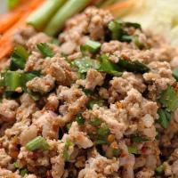 Pork Laab · Minced pork cooked with red onions, carrots, and our house sauce stirred together and sprink...
