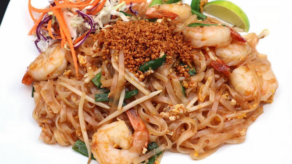 Pad Thai · Famous stir-fried Thai rice noodles with egg, bean sprouts, your choice of meat, and green onions in a tangy and sweet sauce topped with crushed peanuts.