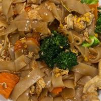 Pad See-Ew · Stir fried wide rice noodles with egg, broccoli, carrots, and your choice of meat in our del...