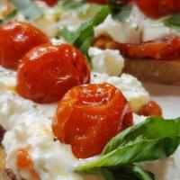 Bruschetta · Fresh baked baguette slices topped with creamy burrata cheese, homemade tomato and basil top...