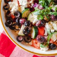 Greco Insalata · Mediterranean blend of cucumbers, tomatoes, red onion, black olives, and feta cheese.